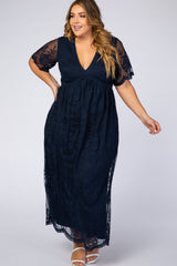 woman wearing a navy blue plus size maxi dress with short lace sleeves and a v-neckline
