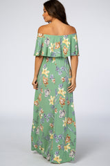 woman wearing a green floral off-the-shoulder maternity maxi dress seen from the back