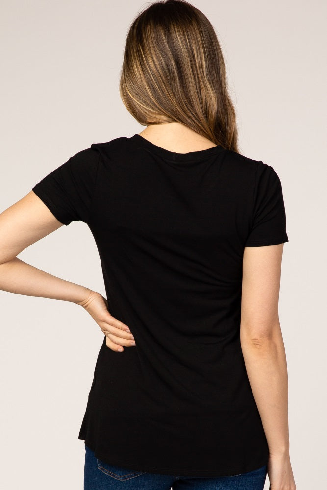 back view of a woman with long brown hair wearing a basic black short sleeve t-shirt and blue jeans