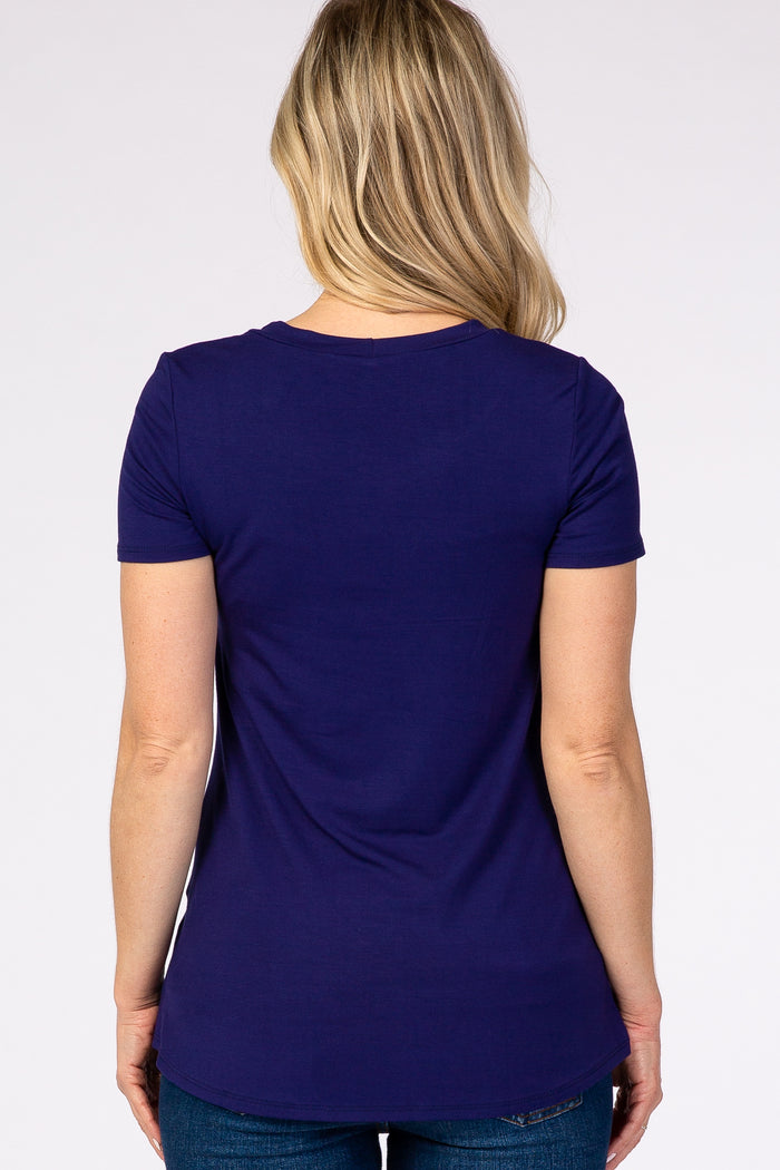 woman wearing a dark purple maternity t-shirt, showing the back view, styled with a fitted silhouette