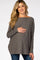 woman wearing a gray long sleeve maternity top and holding her baby bump