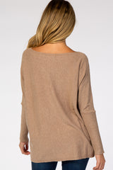 woman wearing a relaxed fit taupe maternity sweater viewed from the back with long sleeves and a wide neckline