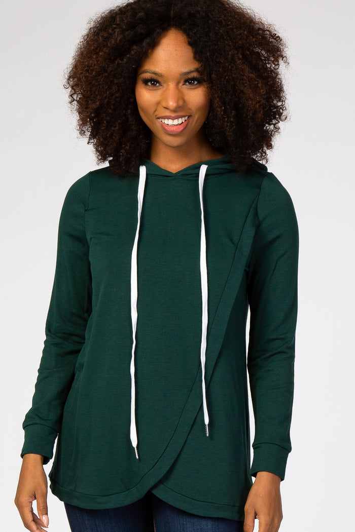 woman wearing a dark green long sleeve hoodie with a crossover front and white drawstrings