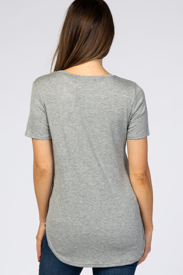 woman wearing a light grey short sleeve maternity top with a rounded hemline, showing a smooth back view