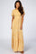 woman wearing a yellow floral maxi dress with short sleeves and a fitted waistline