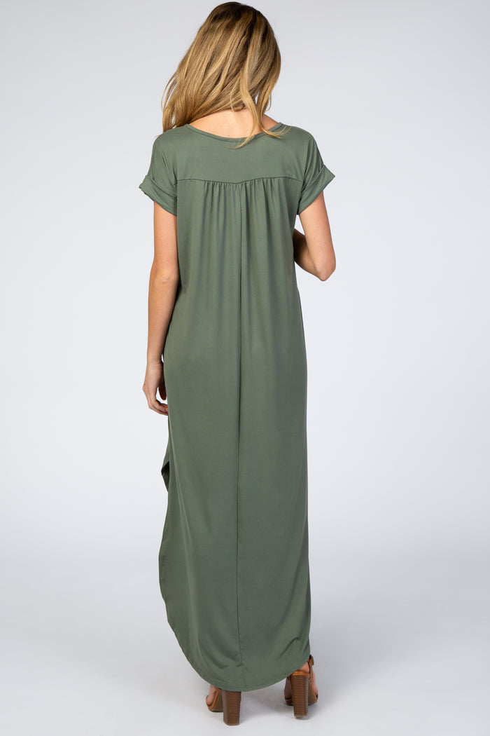 Back view of a woman wearing an olive green short sleeve maxi dress with pleated detail and brown heels