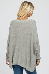 woman wearing a cozy gray oversized knit sweater with a relaxed silhouette and dropped shoulders