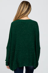 woman wearing a green maternity sweater with a loose fit and drop shoulders, seen from the back