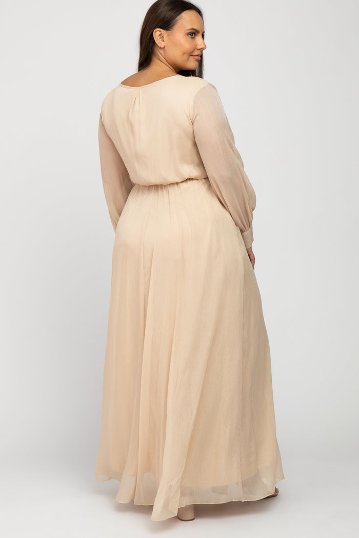 woman wearing a blush long sleeve plus size maxi dress with a cinched waist, shown from the back