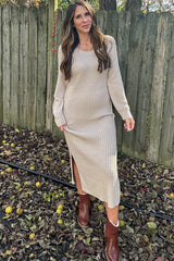 woman wearing a beige ribbed knit long sleeve dress with a side slit and brown ankle boots standing outdoors