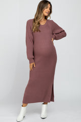 woman wearing a dusty mauve ribbed maternity dress with long sleeves and side slit, showcasing her baby bump