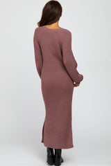 woman wearing a long mauve ribbed knit dress with a fitted silhouette and side slits