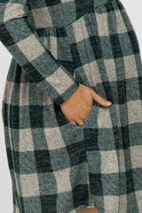 maternity wear in a green and beige plaid long sleeve dress with side pockets and a relaxed fit