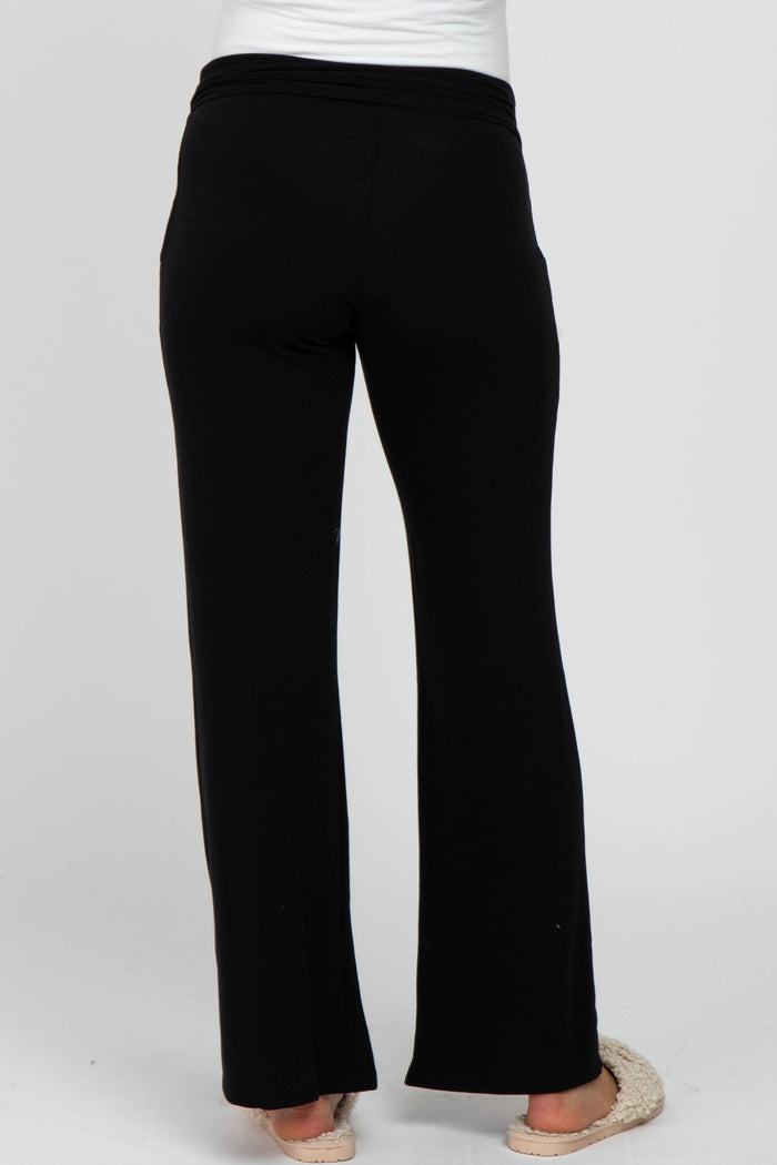 woman wearing black maternity lounge pants, viewed from the back