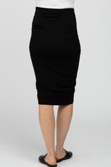 woman wearing a black maternity pencil skirt with ruching details at the sides