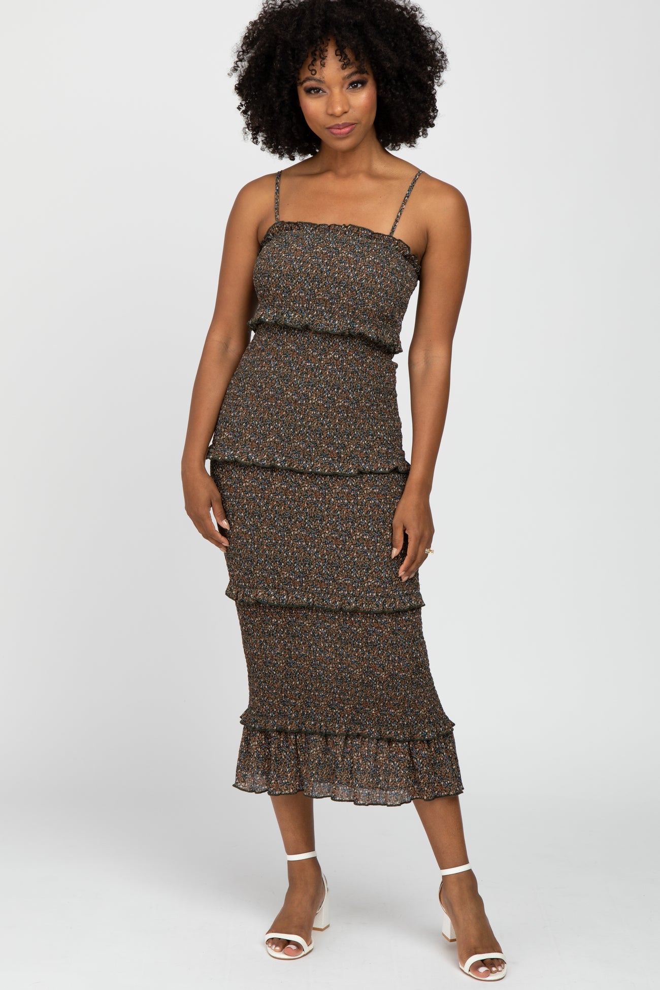 woman wearing a black floral tiered midi dress with spaghetti straps and ruffle hemdetails