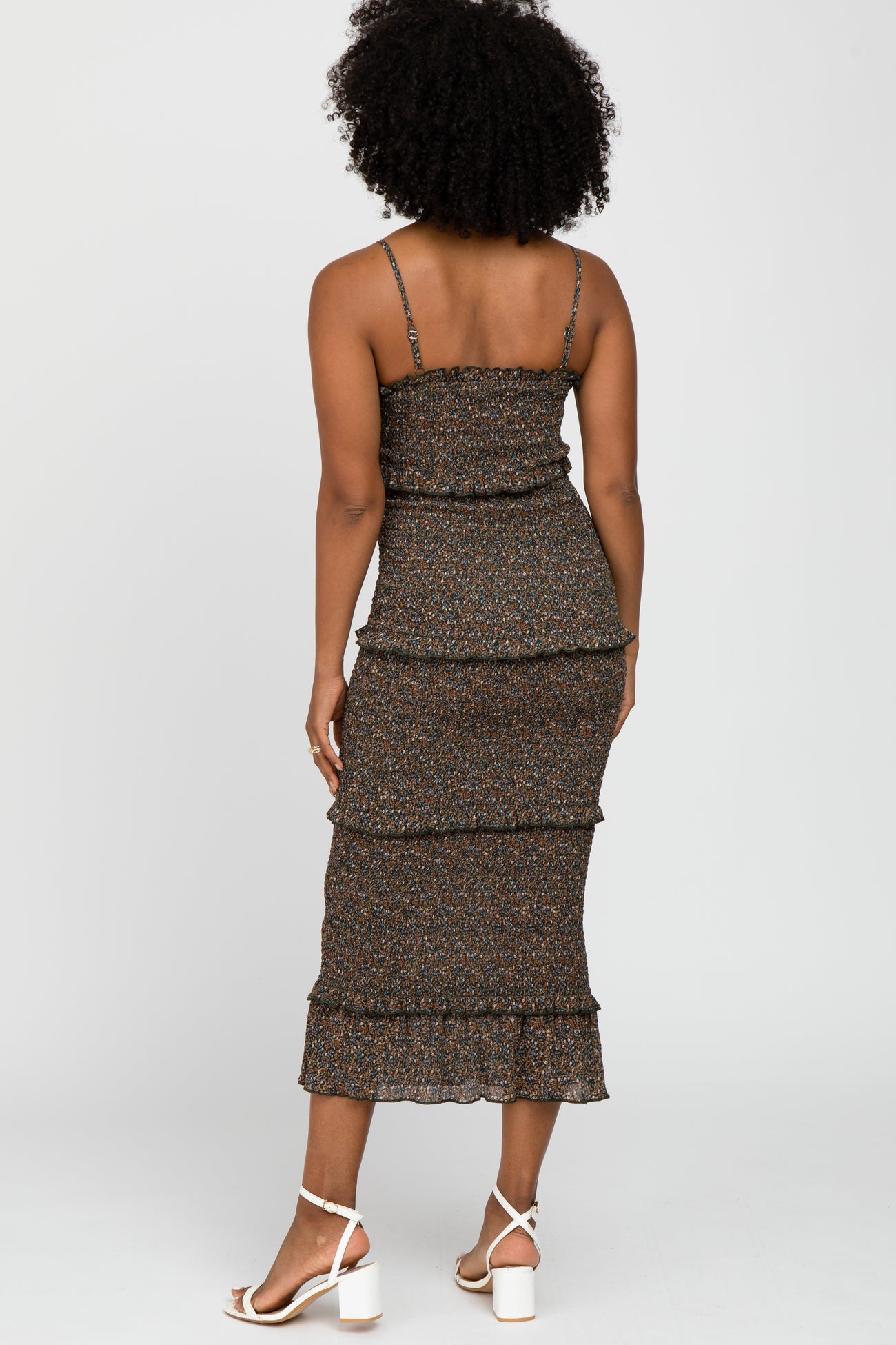 woman wearing a brown floral print tiered midi dress with spaghetti straps and ruffled hem