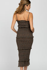 woman wearing a brown floral maternity dress with ruffles, showing her back and thin straps
