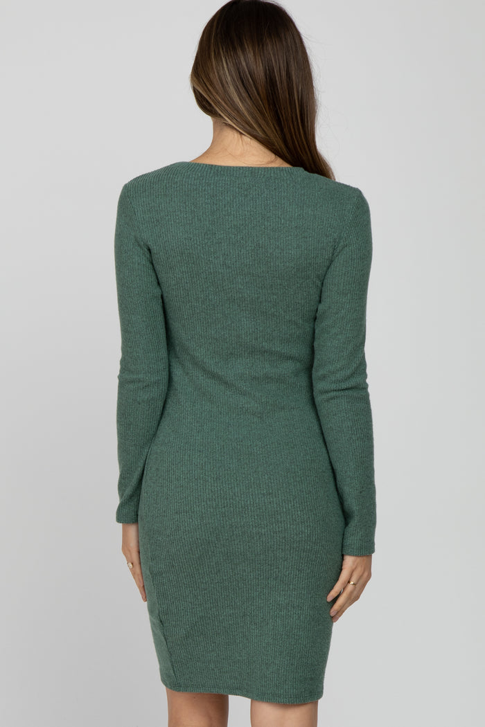 woman wearing a green long sleeve ribbed maternity dress, showing the back view