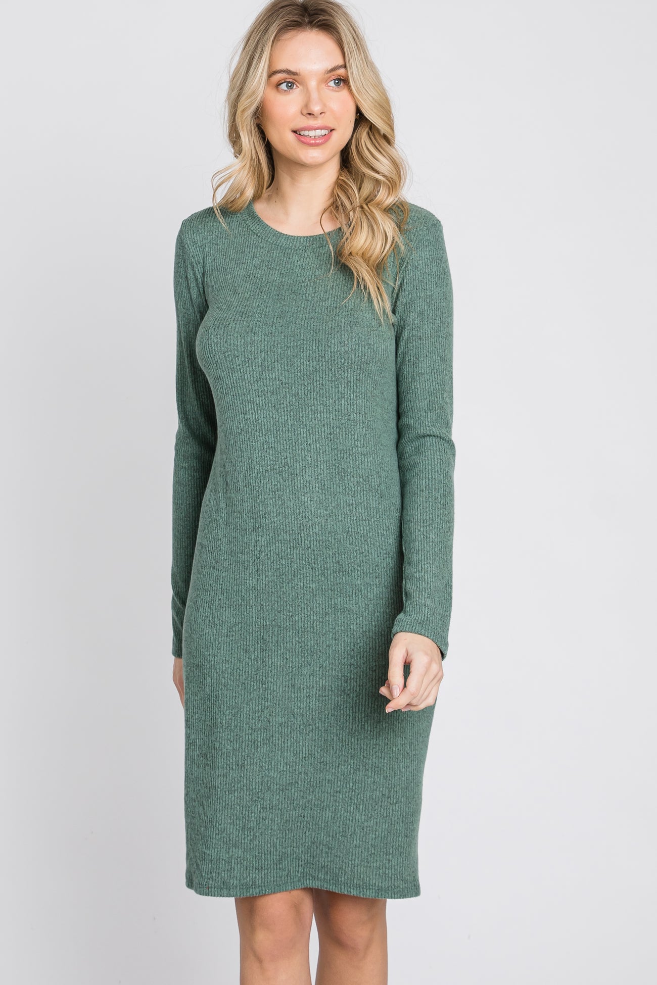 woman wearing a green ribbed long sleeve sweater dress with a relaxed fit
