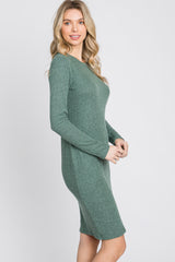 woman wearing a green ribbed long sleeve dress with a form-fitting silhouette