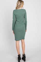 woman wearing a green sweater dress with long sleeves and a fitted silhouette, seen from the back