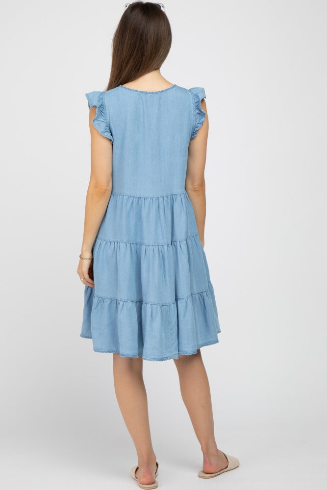 woman wearing a light blue maternity dress with ruffle sleeves and tiered design, showing the back view