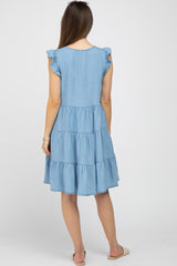 woman wearing a light blue maternity dress with ruffle sleeves and tiered design, showing the back view