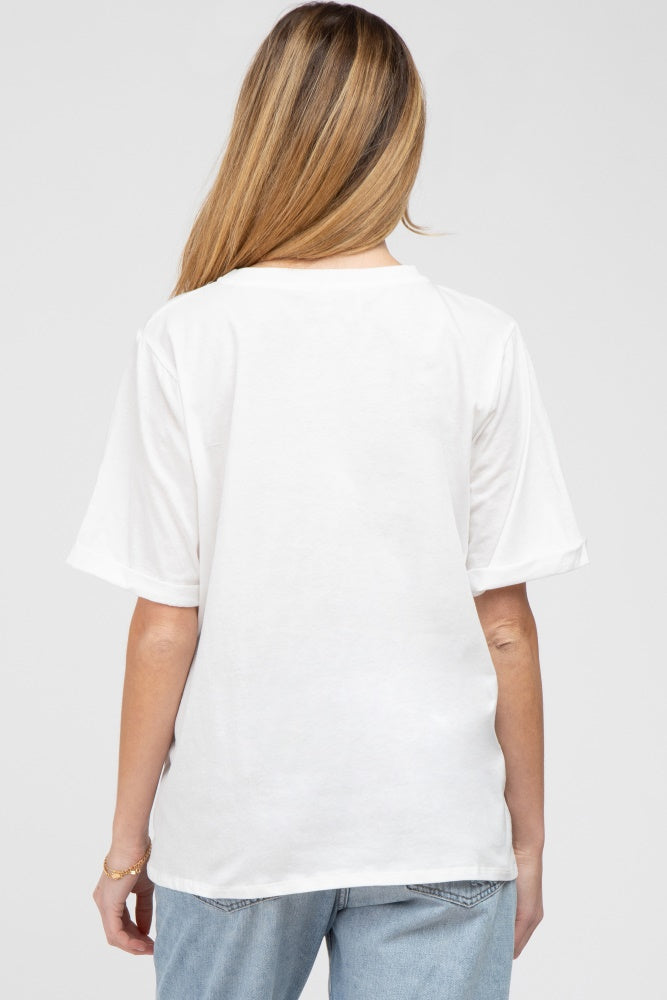 woman wearing a white oversized maternity t-shirt, shown from the back with casual light denim jeans