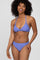 woman wearing a purple triangle bikini top with strappy details and matching bikini bottoms