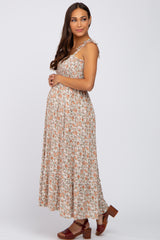 woman wearing a floral maternity maxi dress with adjustable straps and a visible baby bump