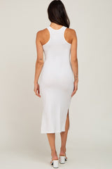 woman wearing a white ribbed midi dress with a racerback and side slit, seen from the back