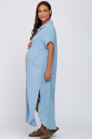 woman wearing a light blue maternity button-up dress with a pocket and side slits, showing her baby bump