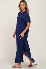 woman wearing a navy blue button-up maxi shirt dress with side slits and short sleeves