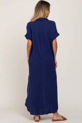woman wearing a navy blue maxi dress with short rolled sleeves and a relaxed fit from the back
