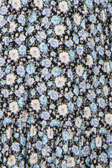 black maternity dress with blue and white floral print and tiered ruffle detail