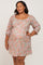 woman wearing a floral maternity plus dress with a square neckline and three-quarter sleeves, showing a baby bump
