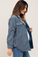 Pregnant woman wearing a blue corduroy maternity shacket with plaid lining and blue jeans