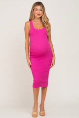 woman wearing a pink ribbed maternity dress that fits snugly over her baby bump