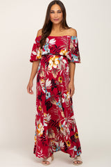 woman wearing a red floral off-the-shoulder maternity dress with ruffled sleeves and a visible baby bump