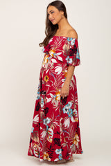 woman wearing a red floral off-the-shoulder maternity maxi dress with ruffled sleeves and a visible baby bump