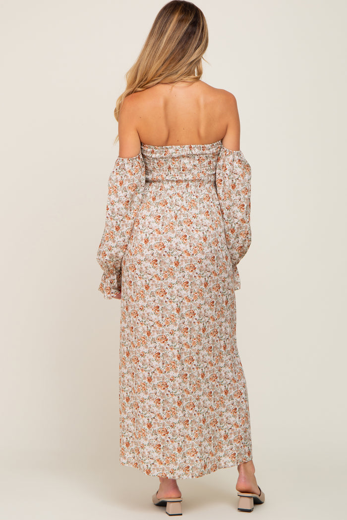 woman wearing a floral off-the-shoulder maternity maxi dress with long sleeves, showing a relaxed fit and back detail