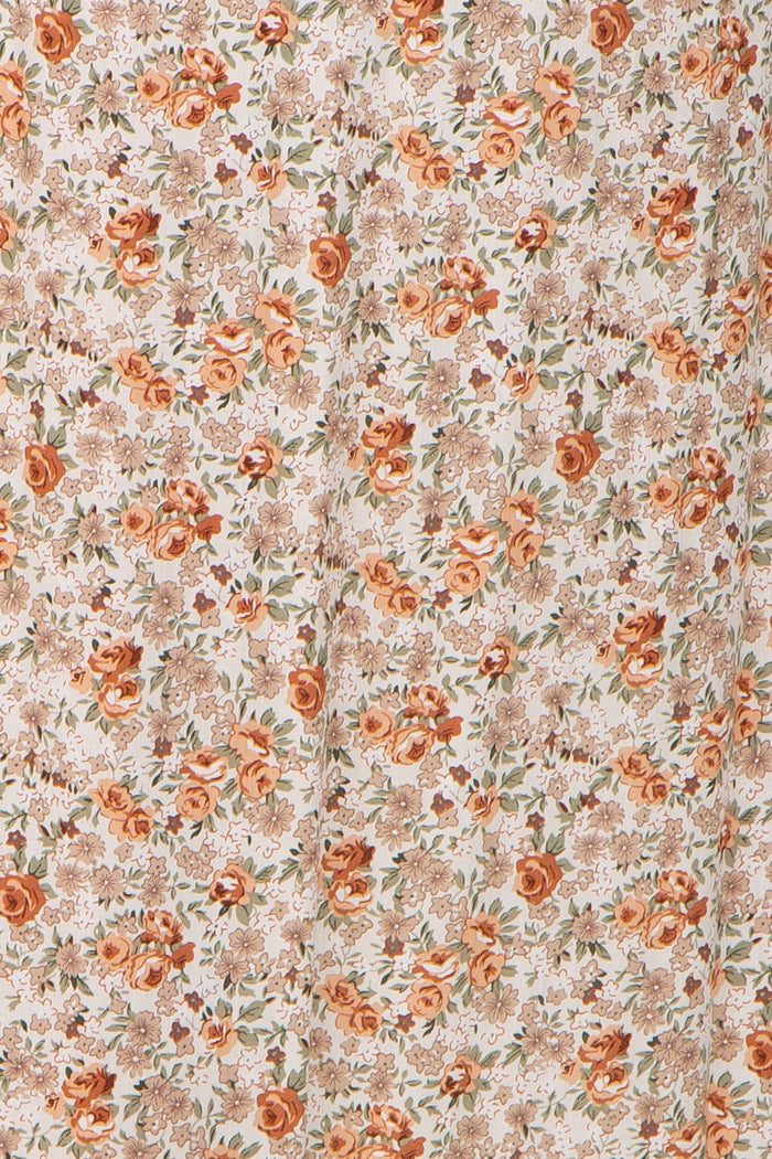 maternity wear floral fabric with orange and beige roses on a light background