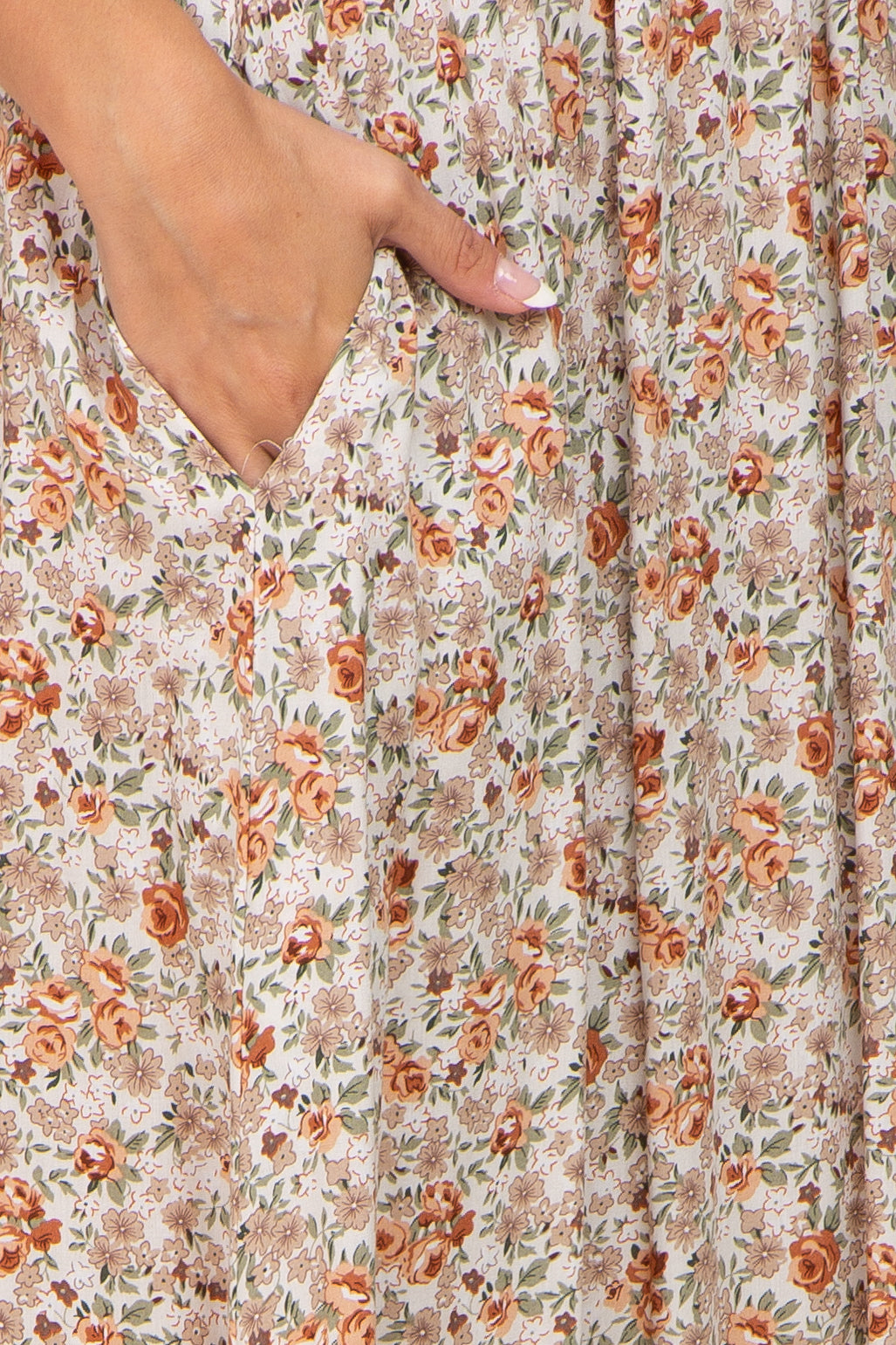 floral print midi dress in soft beige with orange and green accents, featuring side pockets and a relaxed fit