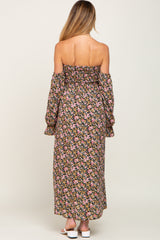 woman wearing a floral off-the-shoulder maternity maxi dress with bell sleeves and a fitted bodice
