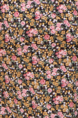 maternity wear in a black fabric with a floral pattern featuring pink roses and yellow flowers