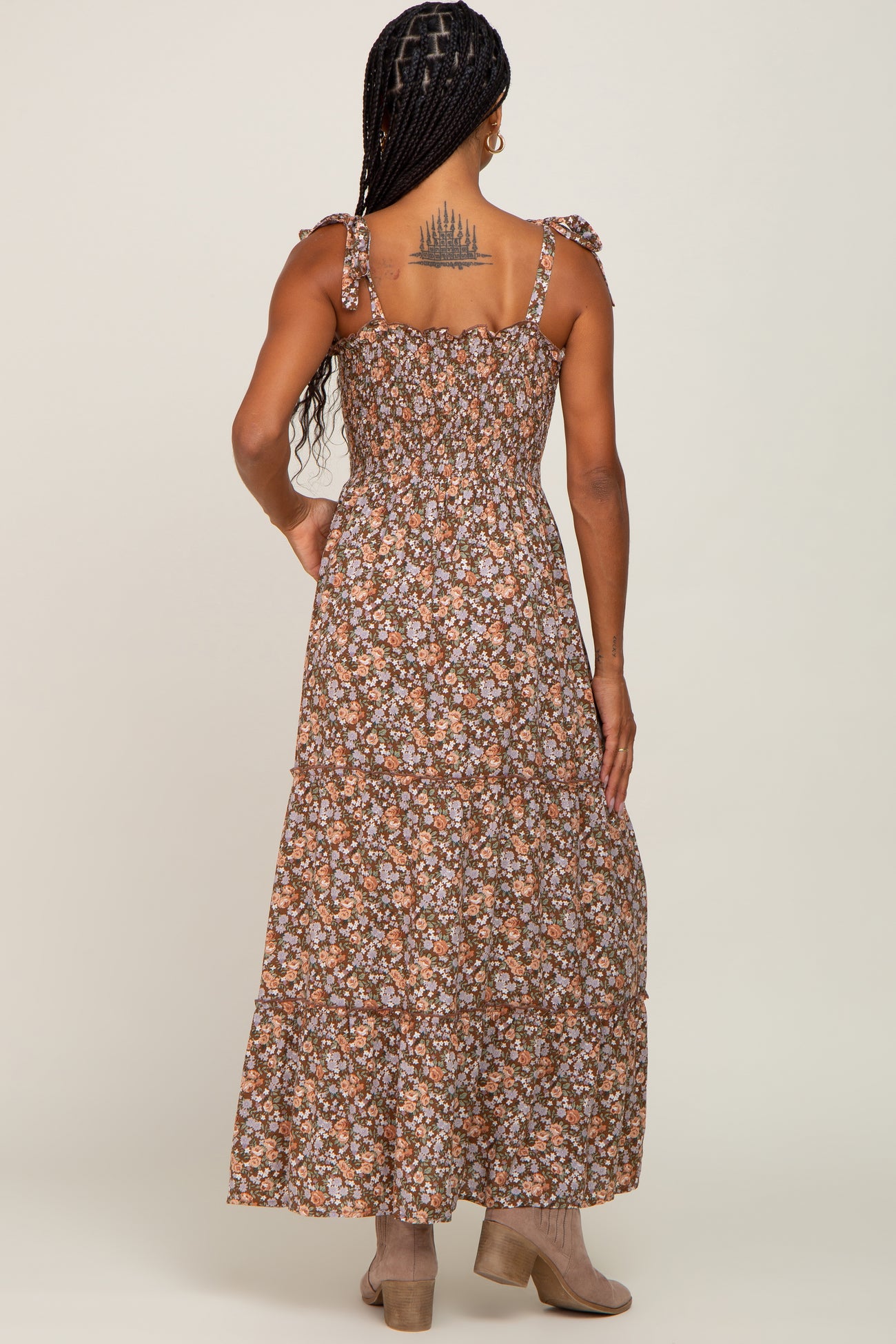 woman wearing a brown floral maxi dress with ruffled straps and a smocked back view