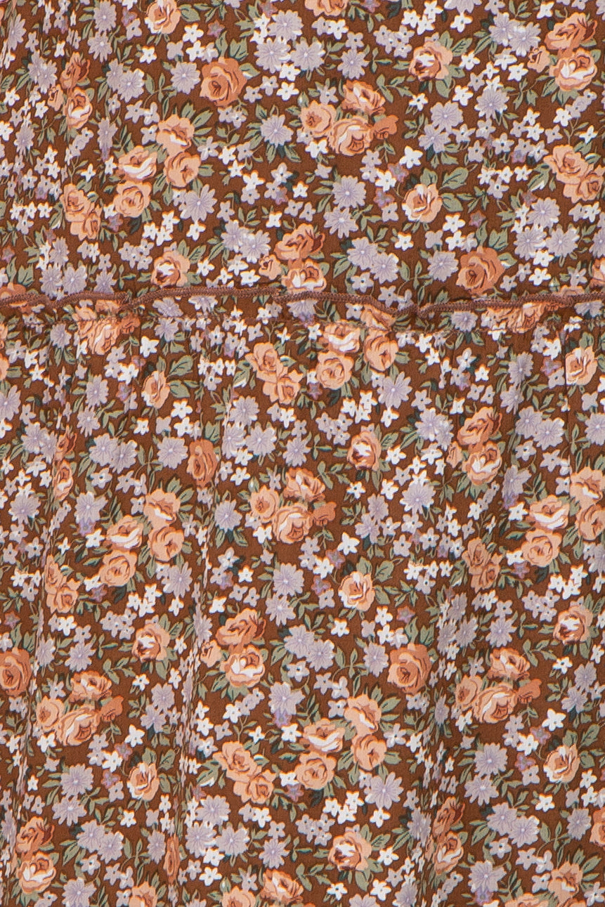 brown floral dress with a tiered design featuring pink and purple flowers