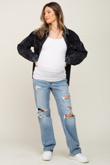 pregnant woman wearing white maternity tank top, black corduroy jacket, and distressed blue jeans
