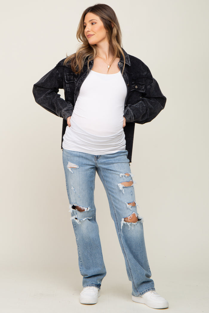 pregnant woman wearing white maternity tank top, black corduroy jacket, and distressed blue jeans